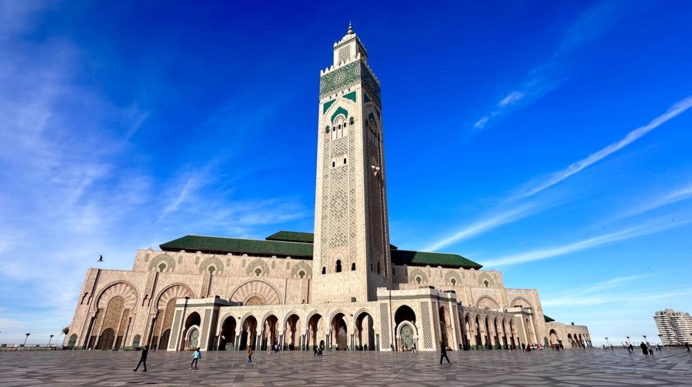 The Hassan II Mosque in Casablanca with its tall minaret rising against a clear blue sky