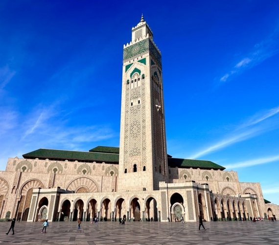 The Hassan II Mosque in Casablanca with its tall minaret rising against a clear blue sky