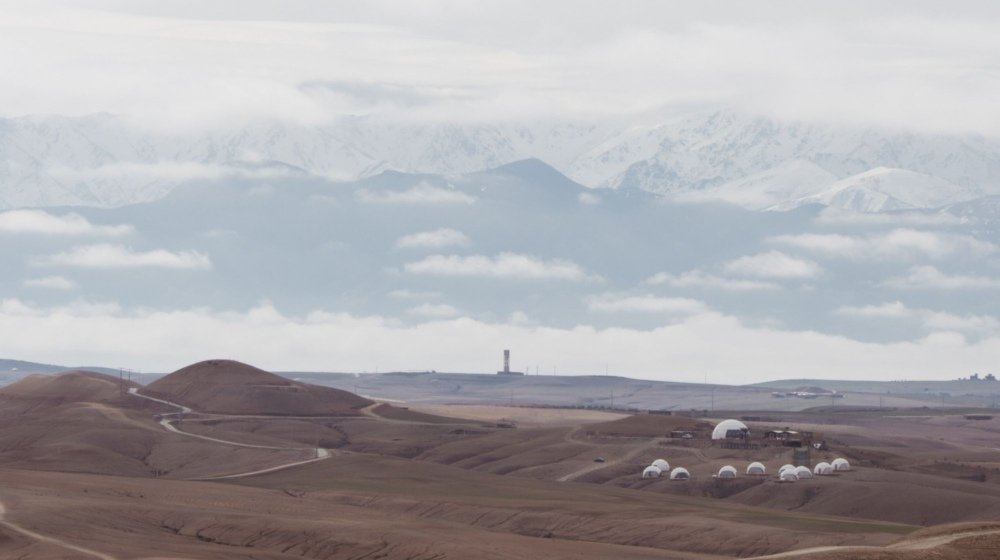 Desert camp tents pitched among the rolling hills of the Agafay Desert near Marrakech