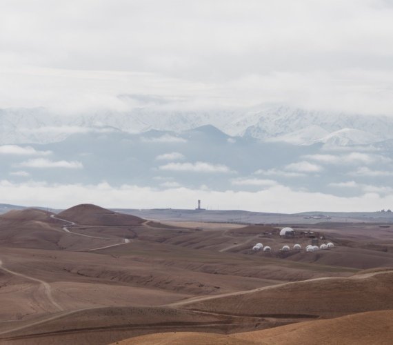 Desert camp tents pitched among the rolling hills of the Agafay Desert near Marrakech