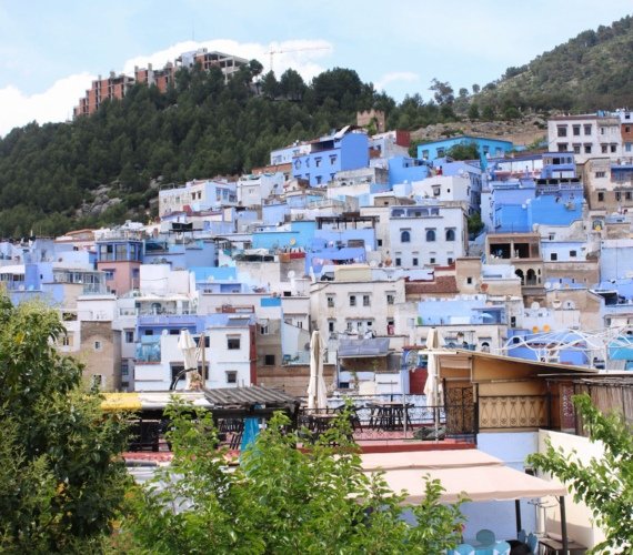 Panoramic view of Chefchaouen's blue-washed houses clustered on the hillside of the Rif Mountains